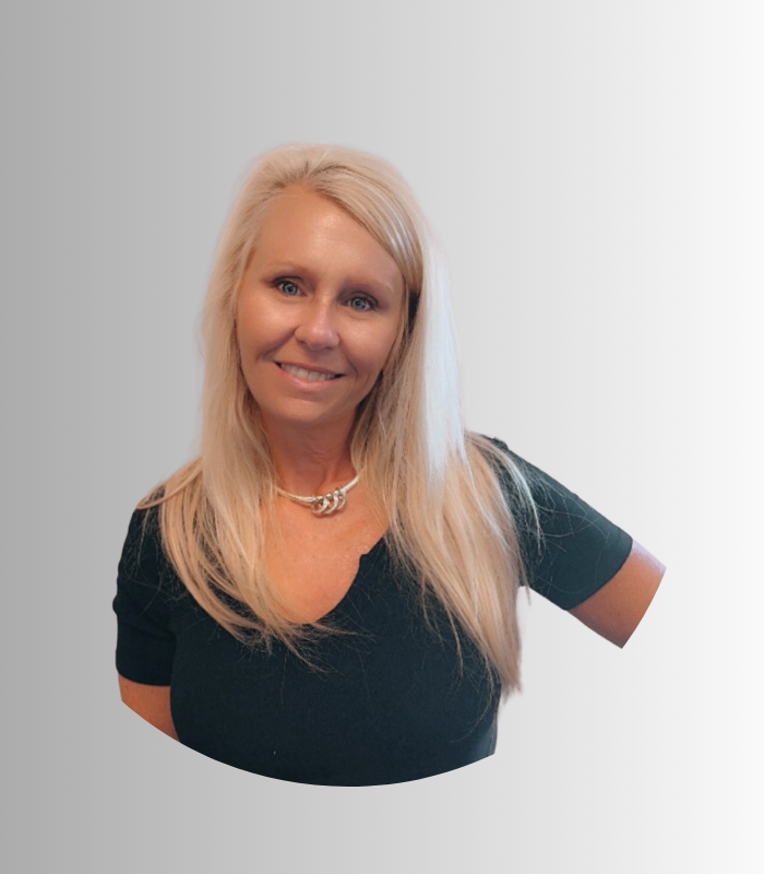 Meet Our Team - Professional and Welcoming Group at a Conference Table Faces the Camera, Team Leader Sitting on the Table with Arms Folded